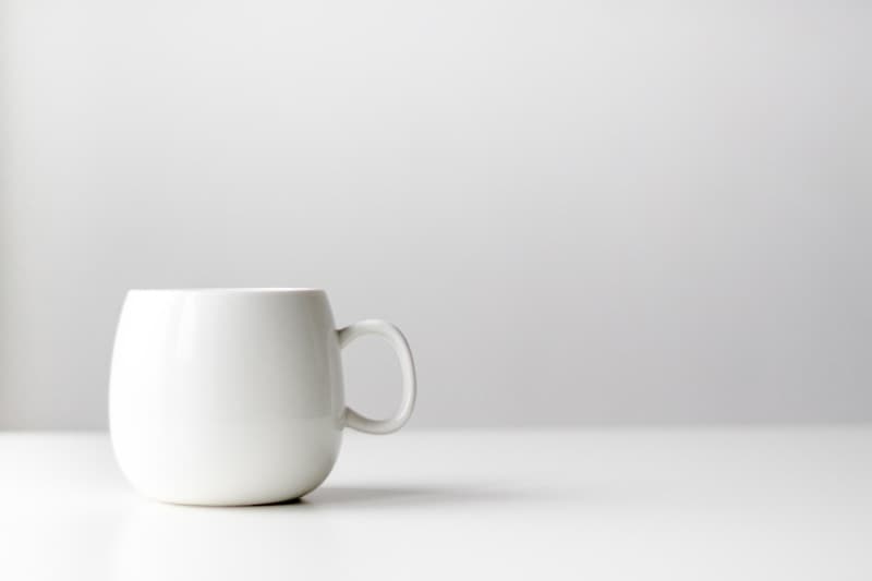 Soft white ceramic mug with a rounded handle